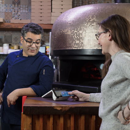 Mos pizza business owner and a customer